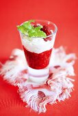 Raspberry jelly with whipped cream in a glass