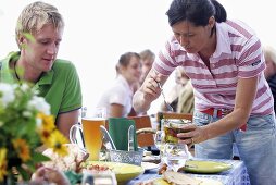 Family at table for summer party out of doors