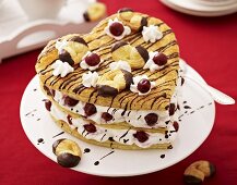 Puff pastry heart with cream and cherries