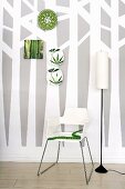 Wallpaper with tree design, chair, standard lamp