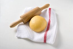 Ball of pasta dough with rolling pin