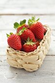 Several strawberries in small basket