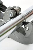 Cutting a chromium rail with a pipe cutter (close-up)