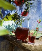 Cherry juice in glass and jug