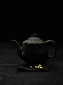 Black teapot with gold