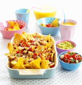 Nachos with salsa and guacamole, orange juice