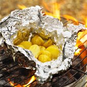 Potatoes in aluminium foil on a barbecue