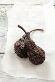 Two dried pears on paper