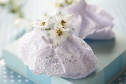 White baby shoes with delphinium flowers