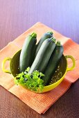 Courgettes and parsley in colander