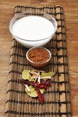 Coconut milk and spices on bamboo mat (Thailand)