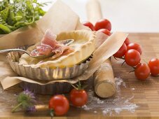 Ingredients for tarts: pastry cases, bacon, tomatoes, herbs