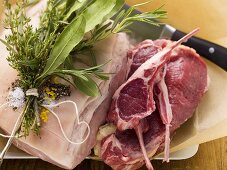 Different kinds of meat with bunch of herbs