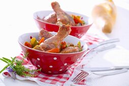 Chicken legs marinated in red wine with carrots and celery