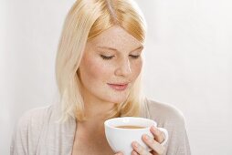 Blond woman with cup of tea