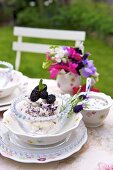 Blackberry dessert with meringue on garden table