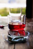 A glass of rosé wine on a wooden table