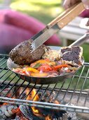 Barbecued beef fillet with vegetables, olive paste on bread