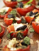 Baked tomatoes stuffed with mozzarella, anchovies and croutons