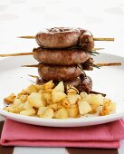 Barbecued sausage coils with fried potatoes