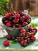 Fresh cherries in and beside pan