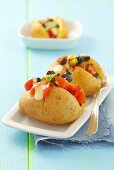 Baked potatoes with tomato and olive salad