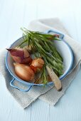 Onions and tarragon in an enamel bowl