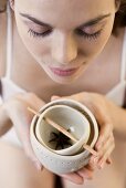 A woman sniffing an oil burner