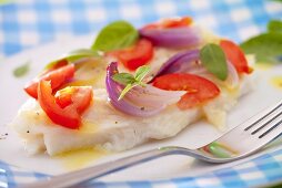 Trout fillets with tomatoes and red onions (close-up)