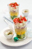Layered vegetable salad in glasses, yoghurt dressing