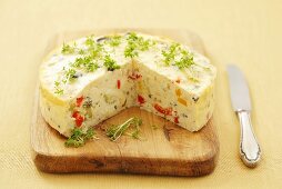 Savory cheesecake with vegetables, herbs and cress