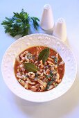 Tripe soup with tomatoes, bay leaves and parsley