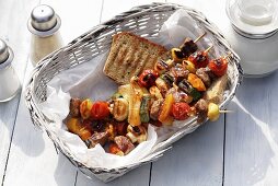 Barbecued mixed kebabs with bread in bread basket