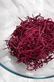 Grated beetroot on glass plate