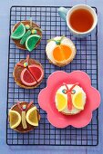 Butterfly and beetle cakes with chocolate, cream and jelly fruit slices