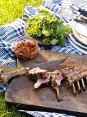 Barbecued rack of lamb (partly sliced) with tomato compote