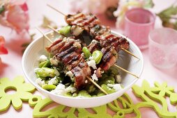 Pork kebabs with broad beans and sheep's cheese