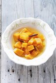Cubes of pickled pumpkin in soup plate