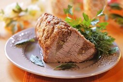 Roast beef garnished with herbs