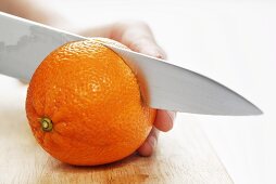 Cutting an orange in half