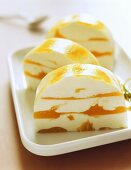 Slices of yoghurt and mango terrine on a plate