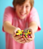 Assorted jelly beans, in a child's hands