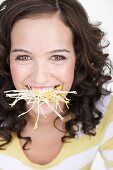 Woman with sprouts in her mouth