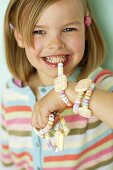 A little girl eating a candy watch
