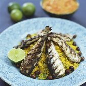 Grilled herrings on couscous salad with olives