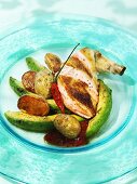 Chicken breast with roasted avocado wedges and potatoes