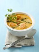 Red curry soup with salmon and asparagus