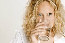 Blond woman drinking a glass of water