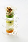 Three kinds of vegetable puree with crayfish in stacked cups