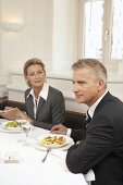Two business people holding a meeting over a meal